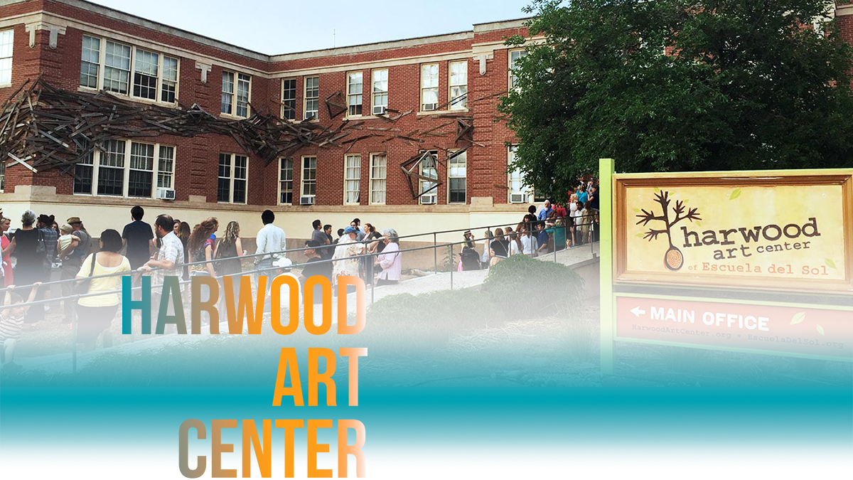 Outdoor view of the downtown Harwood Art Center building surrounded by visitors.