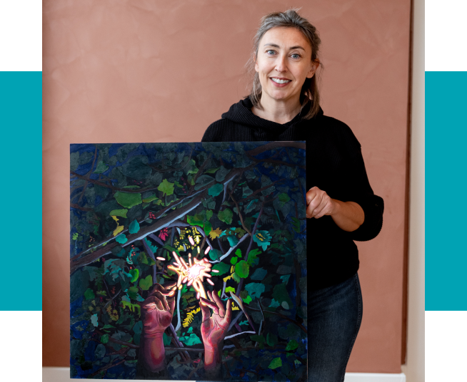Artist Natalie Voelker holds her painting Fire Striker.